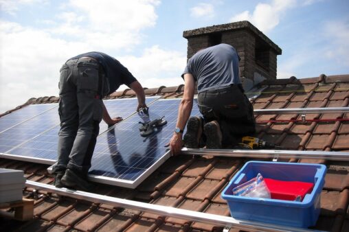 two men installing solar panels