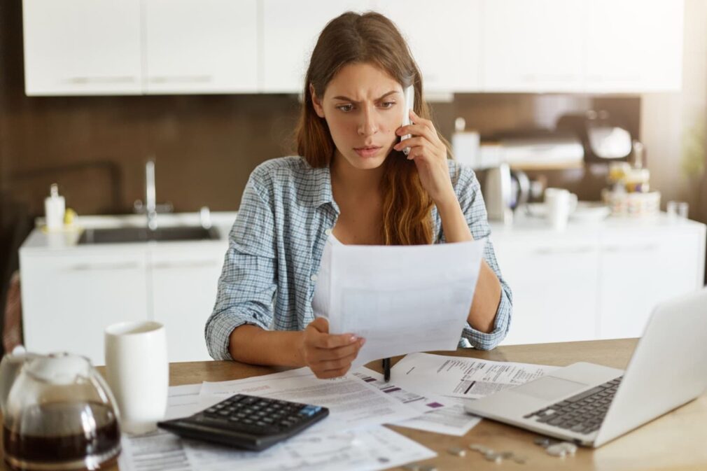 Young woman checking her budget and paying bills