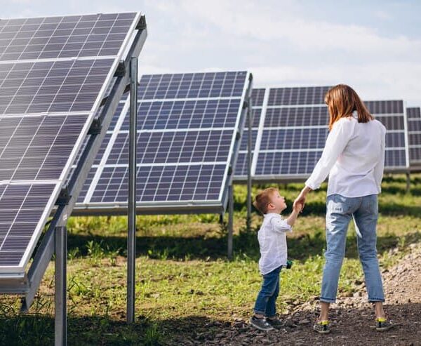 Mother with Little Son near the Solar Panel