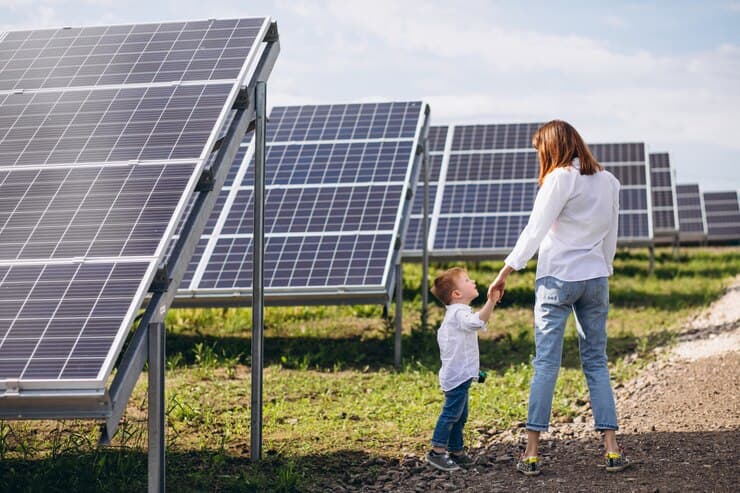 Mother with Little Son near the Solar Panel