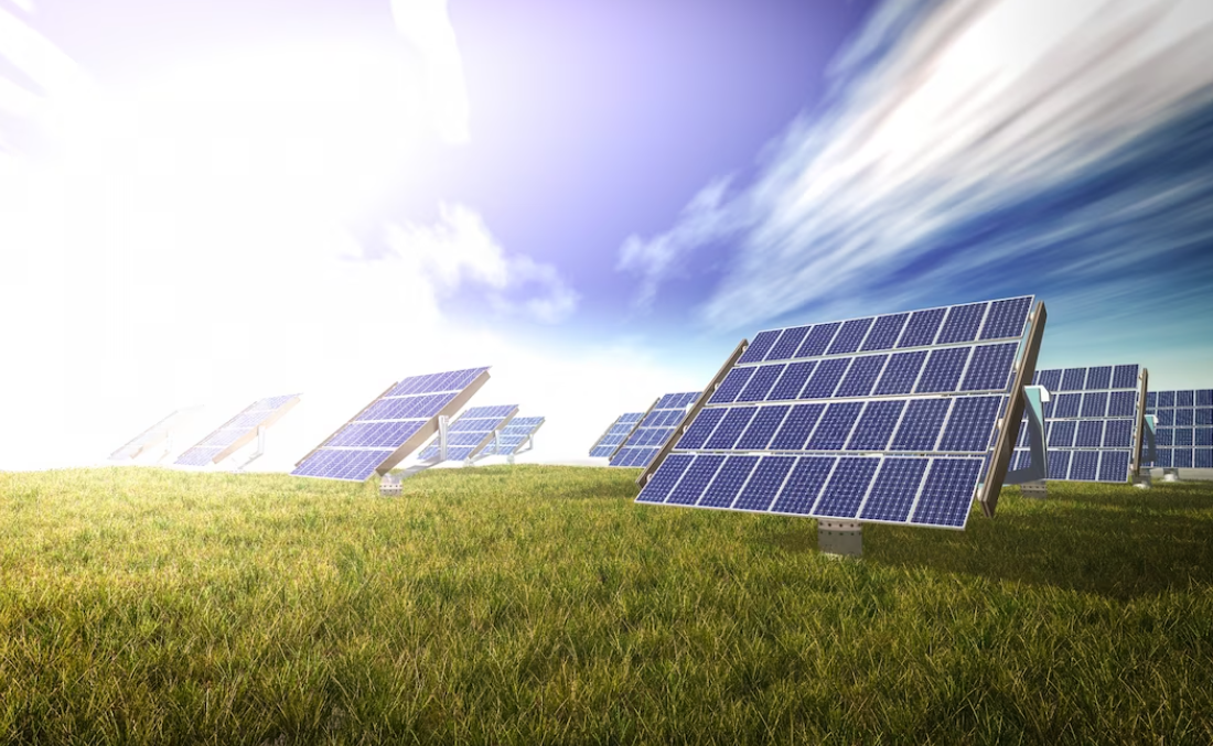 solar panels on the green grass, cloudy blue sky above