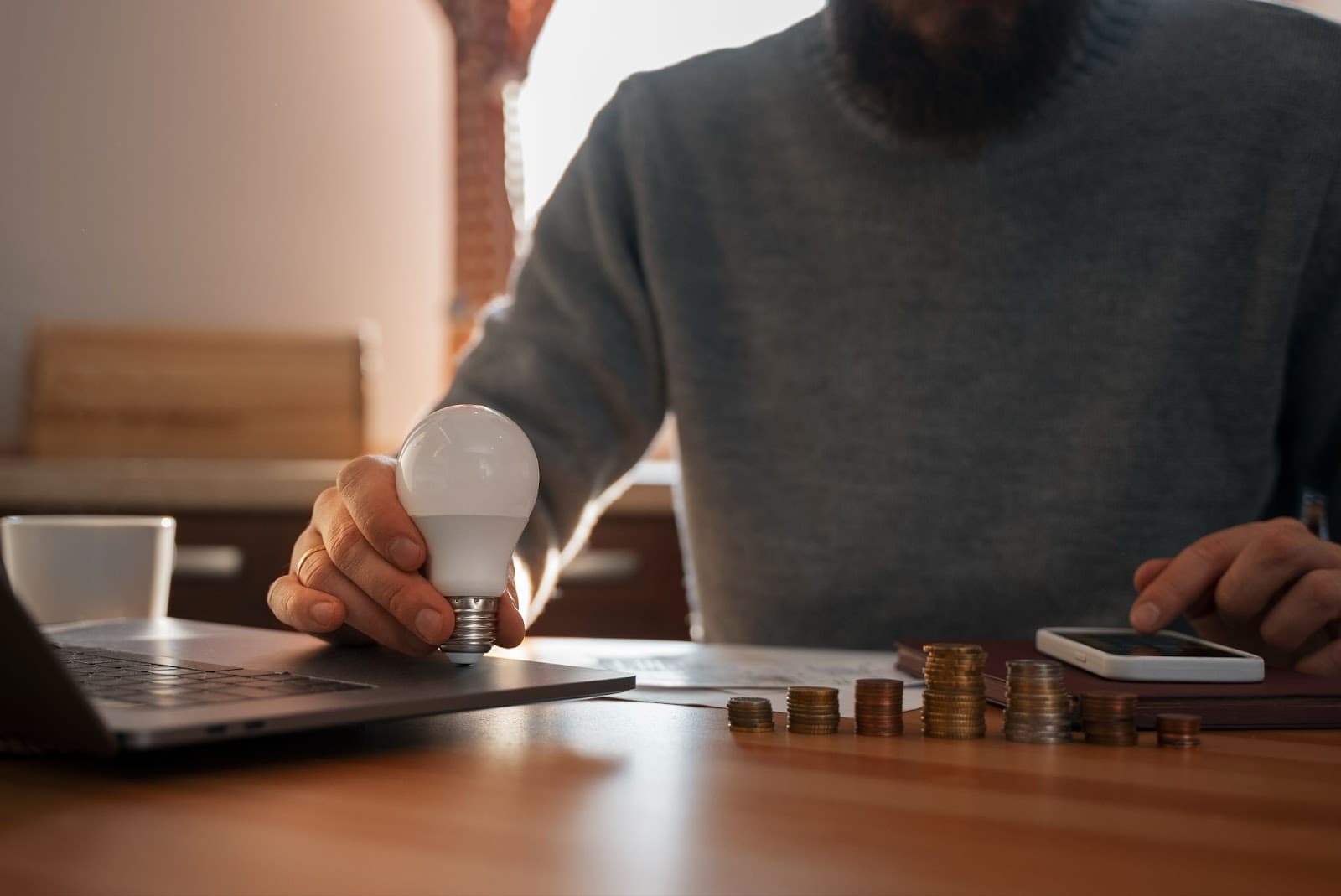 Man saving money to pay electric bills