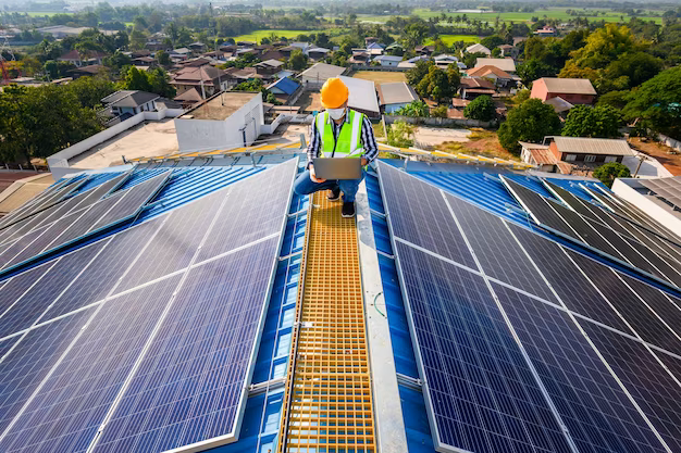 Man on the roof with solar panels